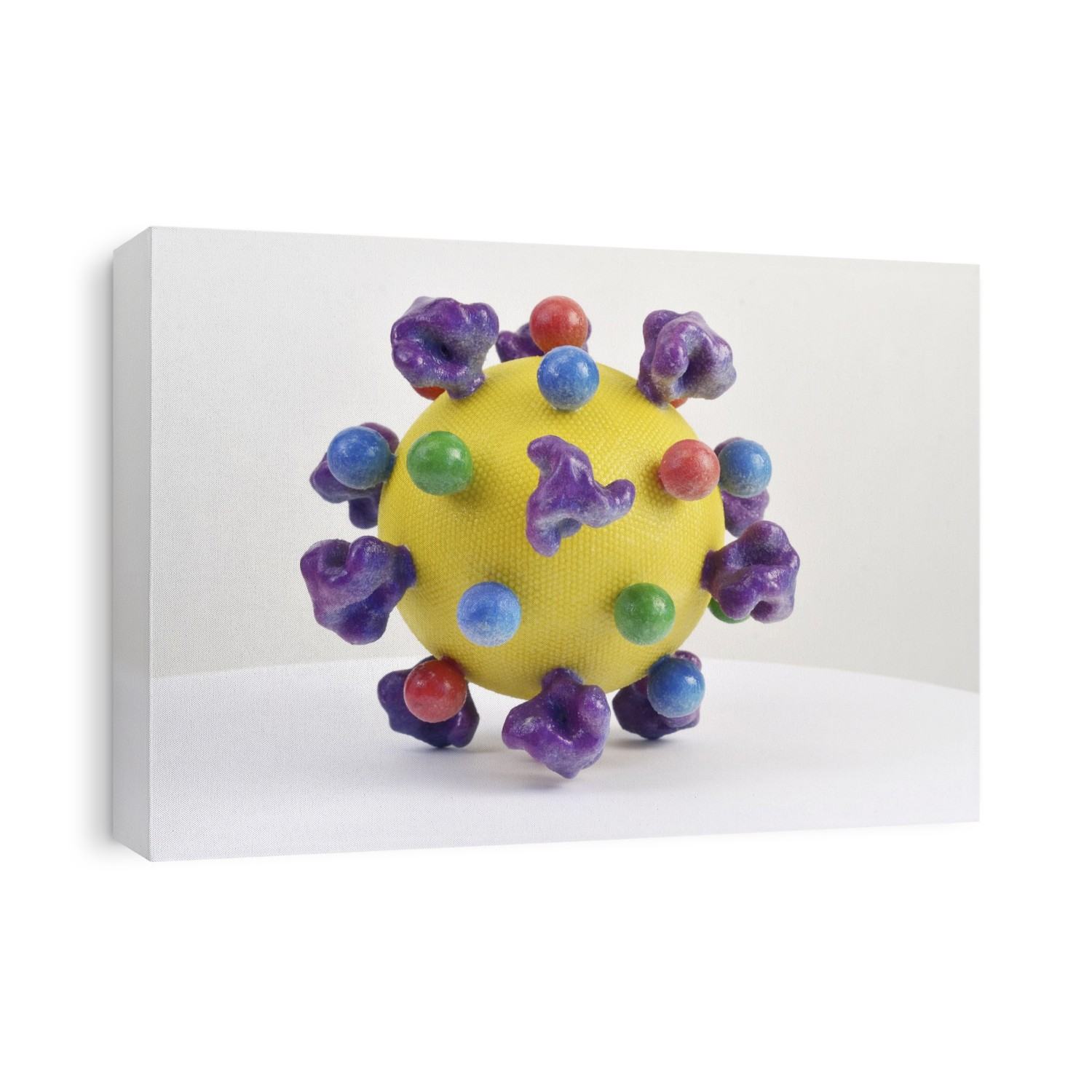 HIV virus particle. 3D printed model of an HIV (human immunodeficiency virus) particle (virion). HIV causes AIDS (acquired immune deficiency syndrome). The virus consists of an RNA (ribonucleic acid) genome, surrounded by an icosahedral (20-sided) protein nucleocapsid. The whole virus is enclosed in an envelope (yellow) derived from the host cell's plasma membrane. The envelope has viral proteins (coloured blobs) integrated into it, including glycoprotein spikes that aid its attachment to host cells. HIV infects the immune system's T-lymphocytes, ultimately killing them, leading to a very weak immune system.